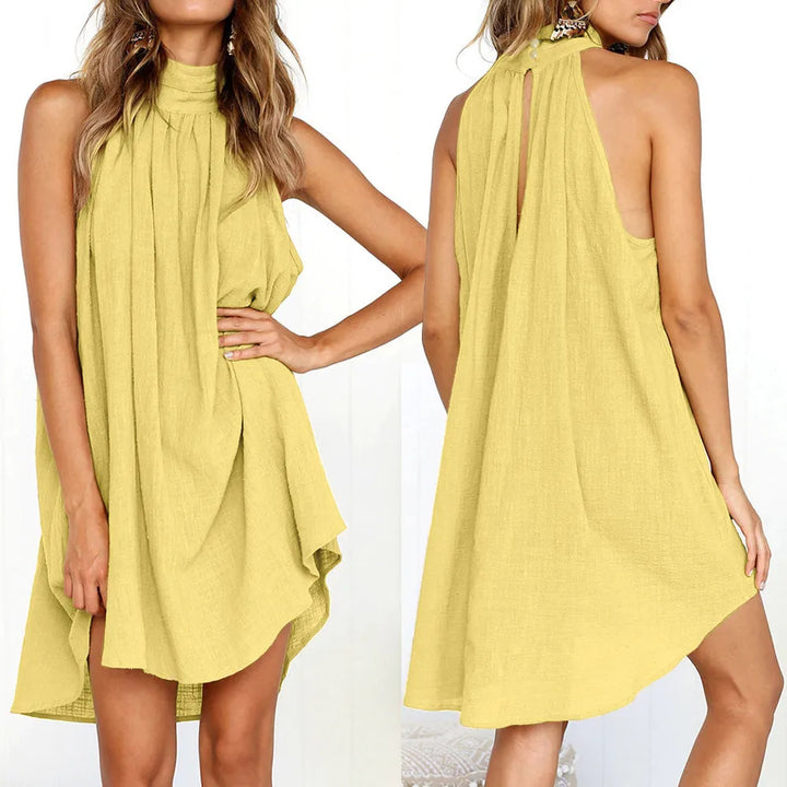 Front and back view of a model wearing the jade irregular summer beach dress with a high neck and asymmetrical hem