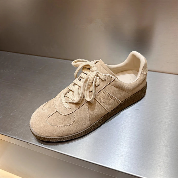 Side view of a light beige Nova genuine leather sneaker with matching laces and a dark tan sole