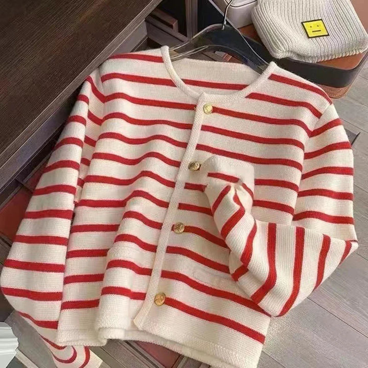 Flat lay of a red and cream striped knit crop cardigan with gold buttons