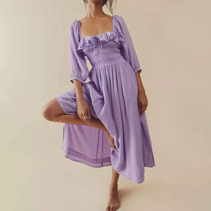 Fairycore square neckline mid-calf dress, worn by model in a purple dress, one leg raised, bare feet