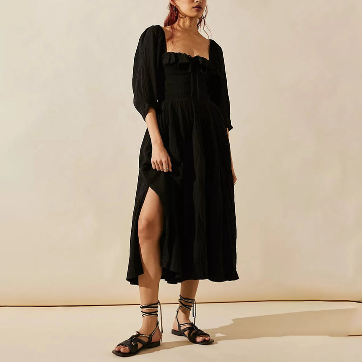 Fairycore square neckline mid-calf dress, front view worn by model, a woman in a black dress with a leg slit
