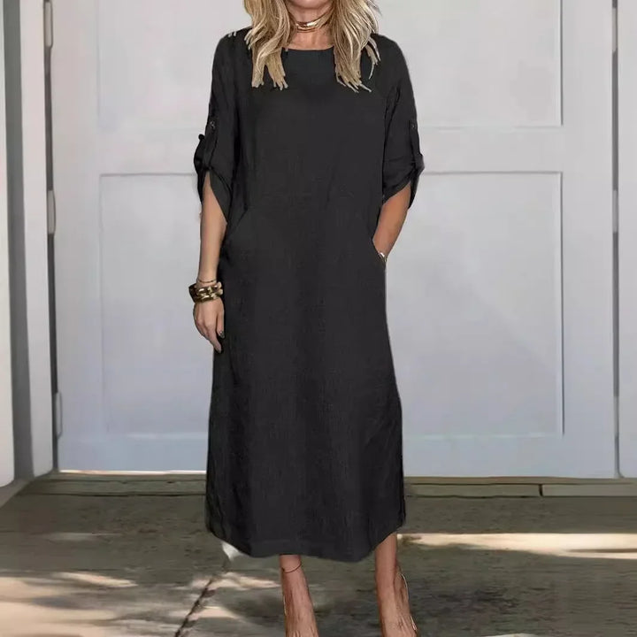 Front view of the Emma Linen Midi Dress in black, with rolled short sleeves and a model&
