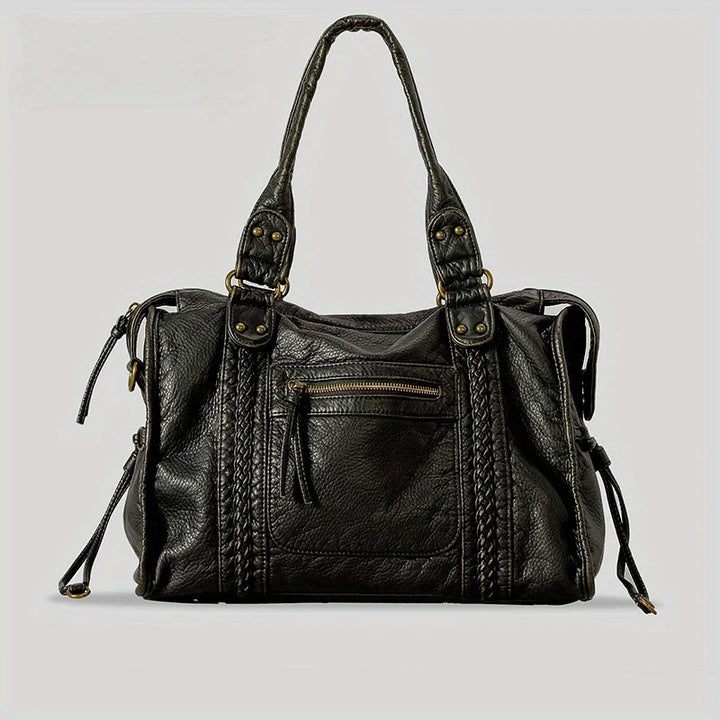 Front view of the Sienna vintage washed leather tote bag in black with braided details and a front zip pocket