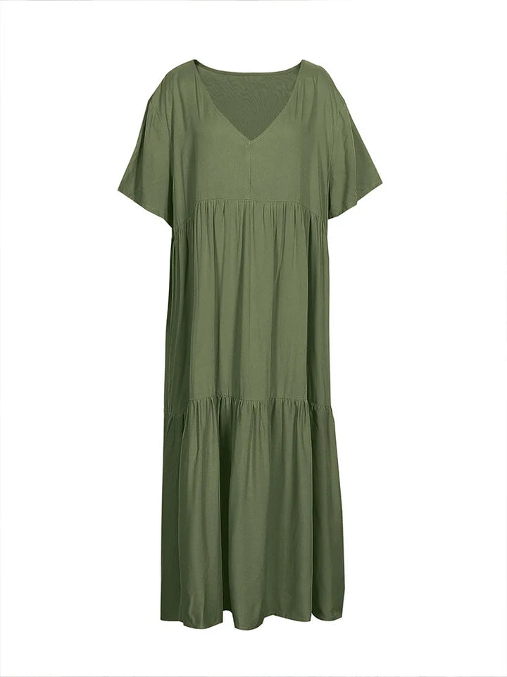 Flat lay of a plus size V-neck midi dress in olive green with pleated detail and short sleeves