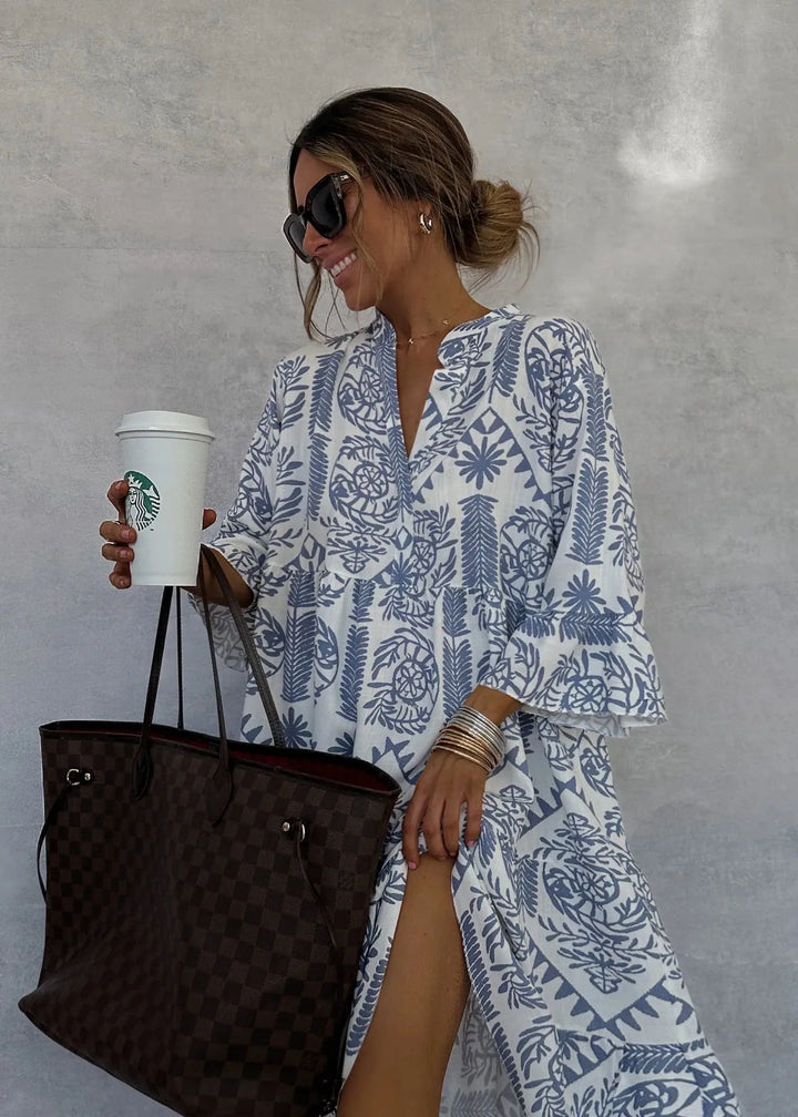 White and blue printed V neck dress with a tote bag, close up
