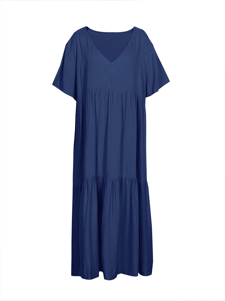 Front flat lay of a dark blue plus size V-neck midi dress with pleated detail and short sleeves