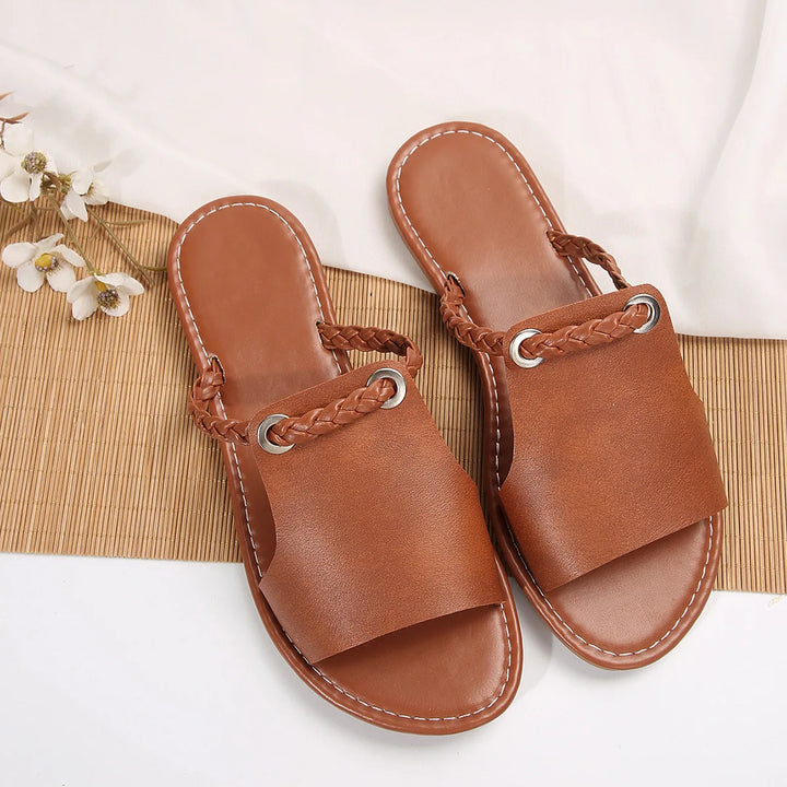 Top view of a pair of brown Maya Square-Toe Flat Sandals with braided straps and silver eyelets