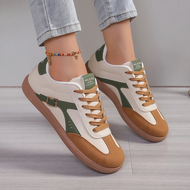 Front view of Luna soft-soled casual sneakers with beige, green, and brown panels worn by model
