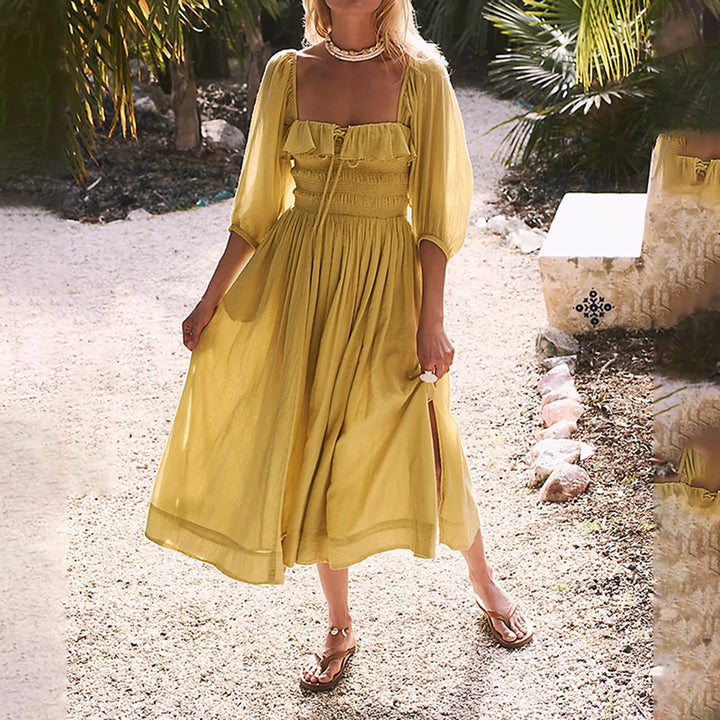 Fairycore square neckline mid-calf dress, three quarter view worn by model, a woman in a yellow dress with sandals