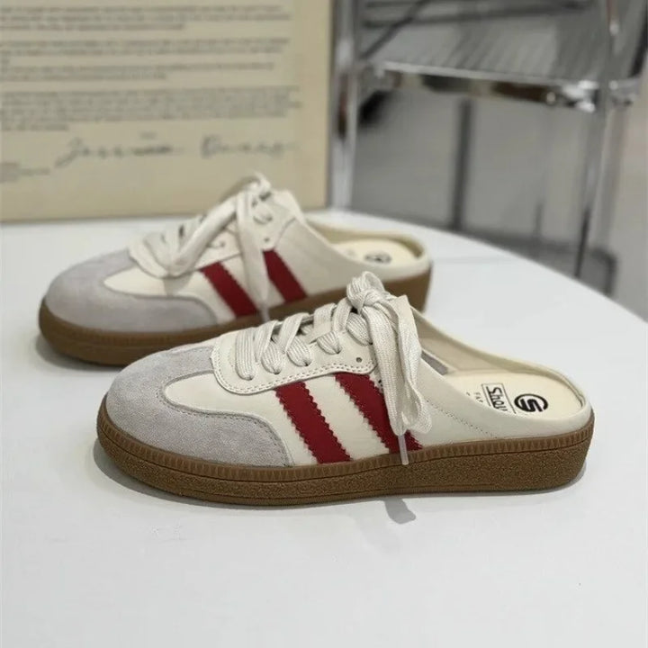 Back view of two beige casual platform slip-on mules with red stripes and a patchwork design