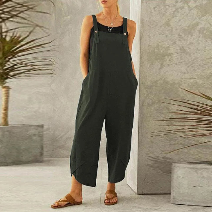 Front view of a model wearing the dark green Isla oversized cotton-linen summer overalls with a black top
