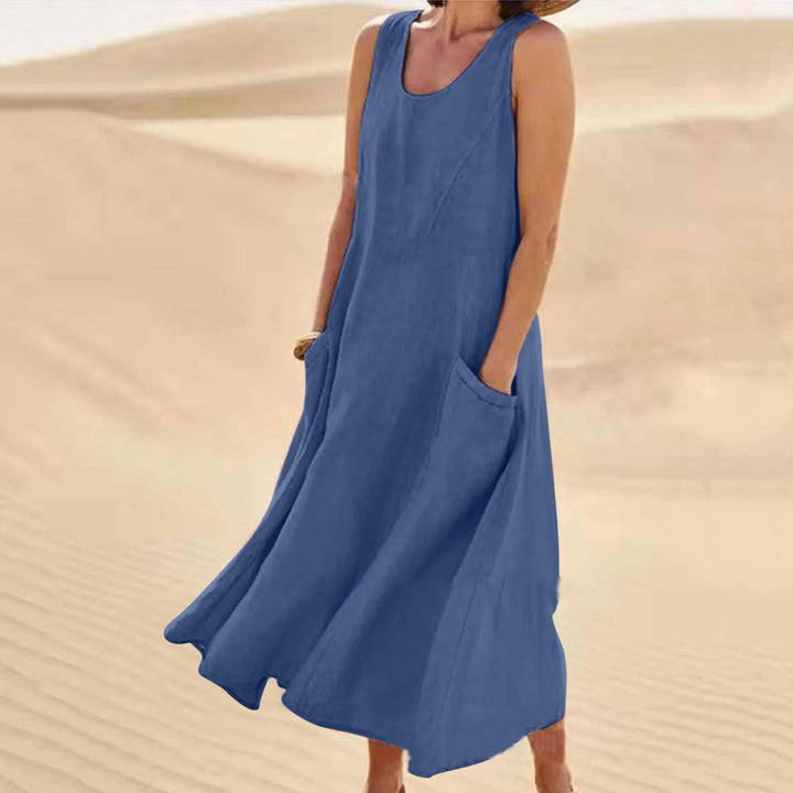 Front view of Anna A-Line Sleeveless Midi Dress in blue with pockets, worn by model on sand dunes