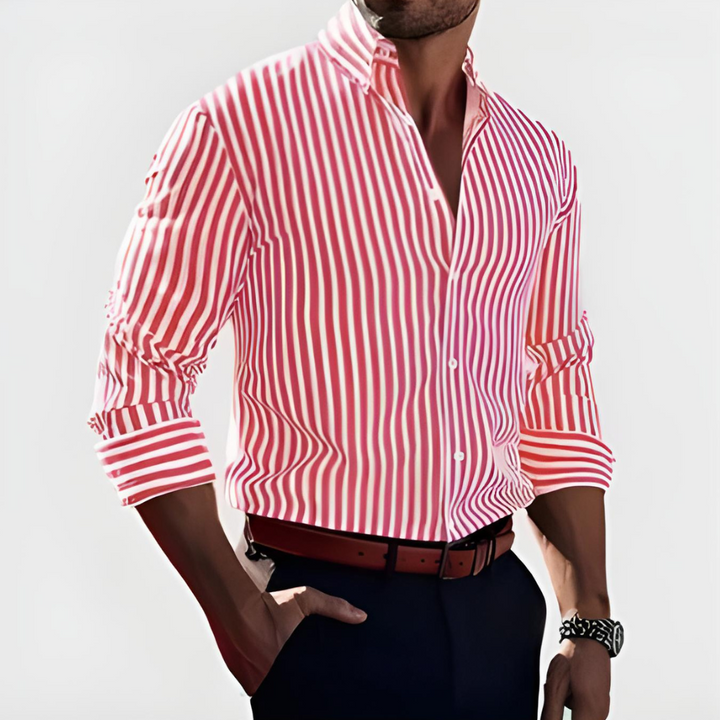 Front view of a man wearing a red and white striped long sleeve shirt with rolled sleeves and dark trousers