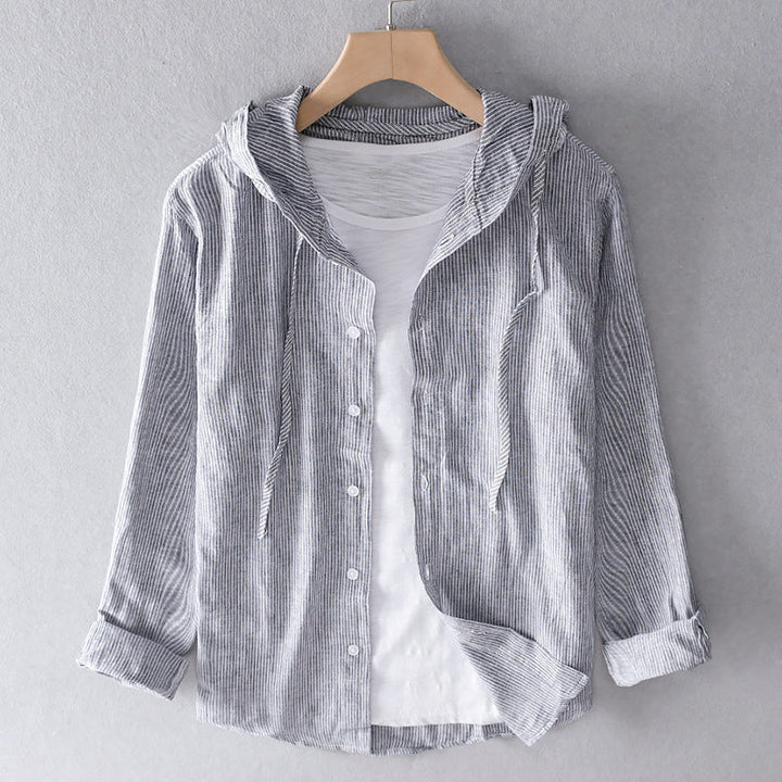 Front view of a grey and white striped linen blend hooded shirt, unbuttoned over a white tee
