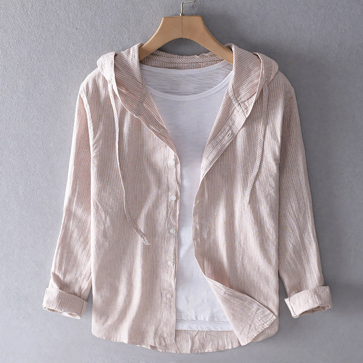 Front view of a light beige striped linen blend hooded shirt, unbuttoned and layered over a white tee