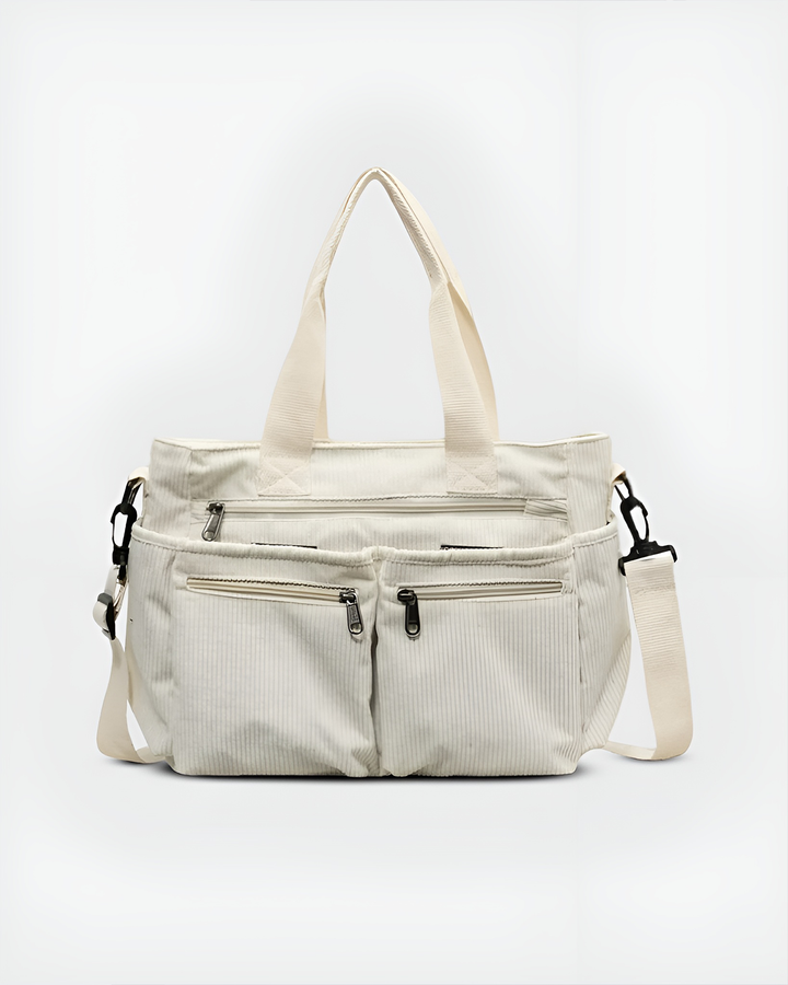 Front view of the Urban Cord Tote Bag in cream corduroy with two top handles and a long adjustable shoulder strap