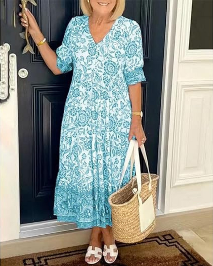 Elegant Summer Dress worn by model, front view, with blue and white floral print and white sandals