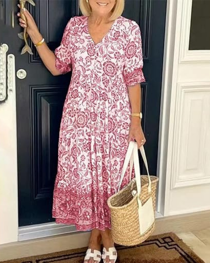 Elegant Summer Dress worn by model, front view, with red and white floral print and straw bag
