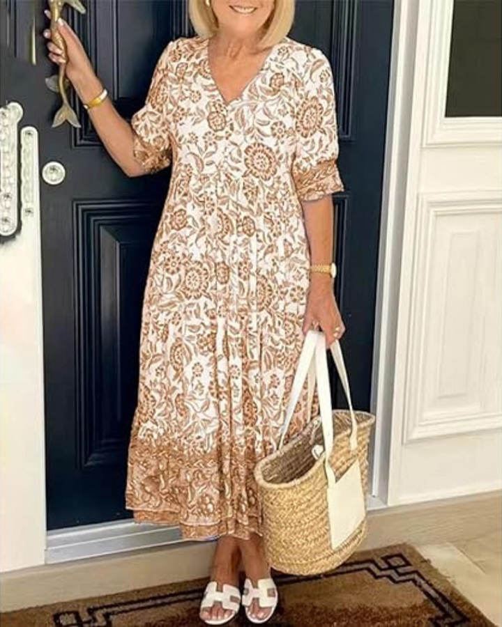 Elegant Summer Dress worn by model, front view, with brown and white floral print and straw bag