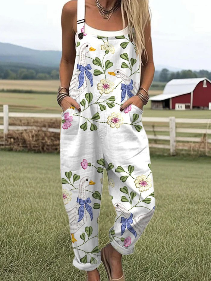 Front view of a Penelope vintage floral jumpsuit worn by model with a white tank top, hands in pockets