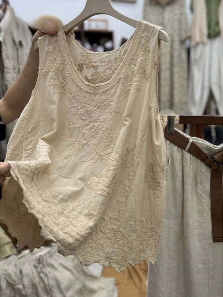 Back view of a beige vintage lace sleeveless cotton linen vest top with floral embroidery and a scalloped hem