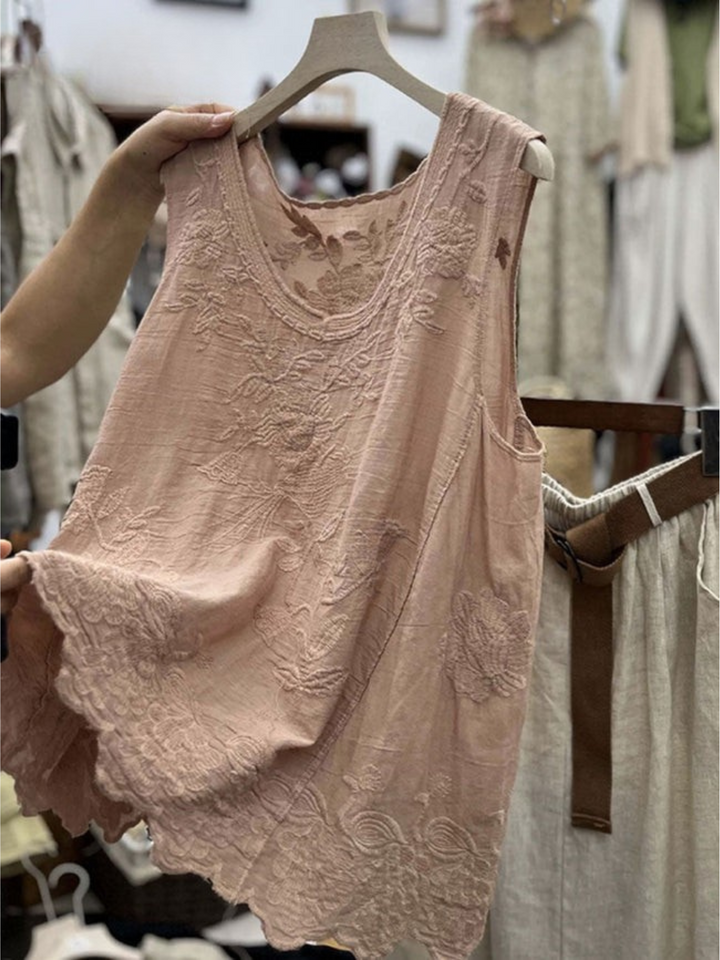 Front view of a pink vintage lace sleeveless cotton linen vest top with floral embroidery and a scalloped hem