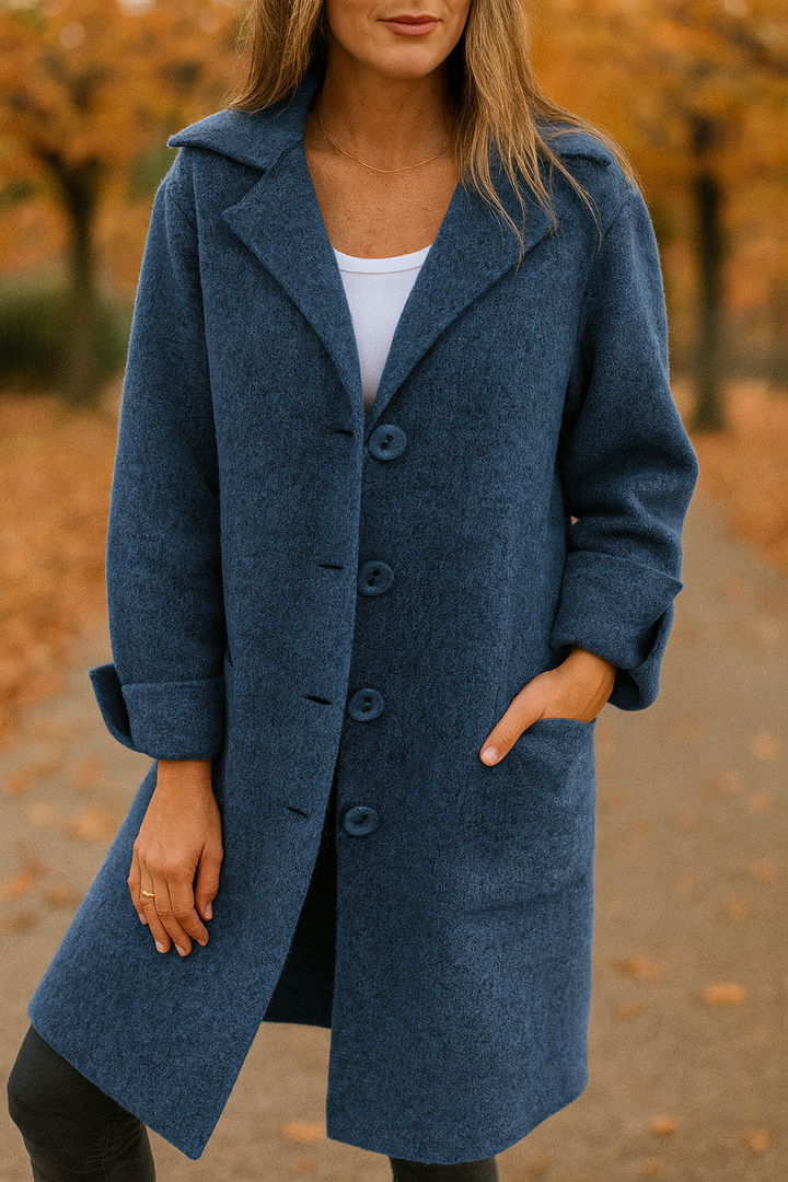 Front three quarter view of a model wearing the Madison Elegant Mid-Season Jacket in blue, with hand in pocket