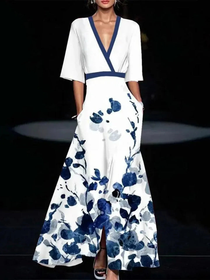 Front view of a model wearing the Yasmine elegant puff sleeve dress in white with blue floral print and side pockets