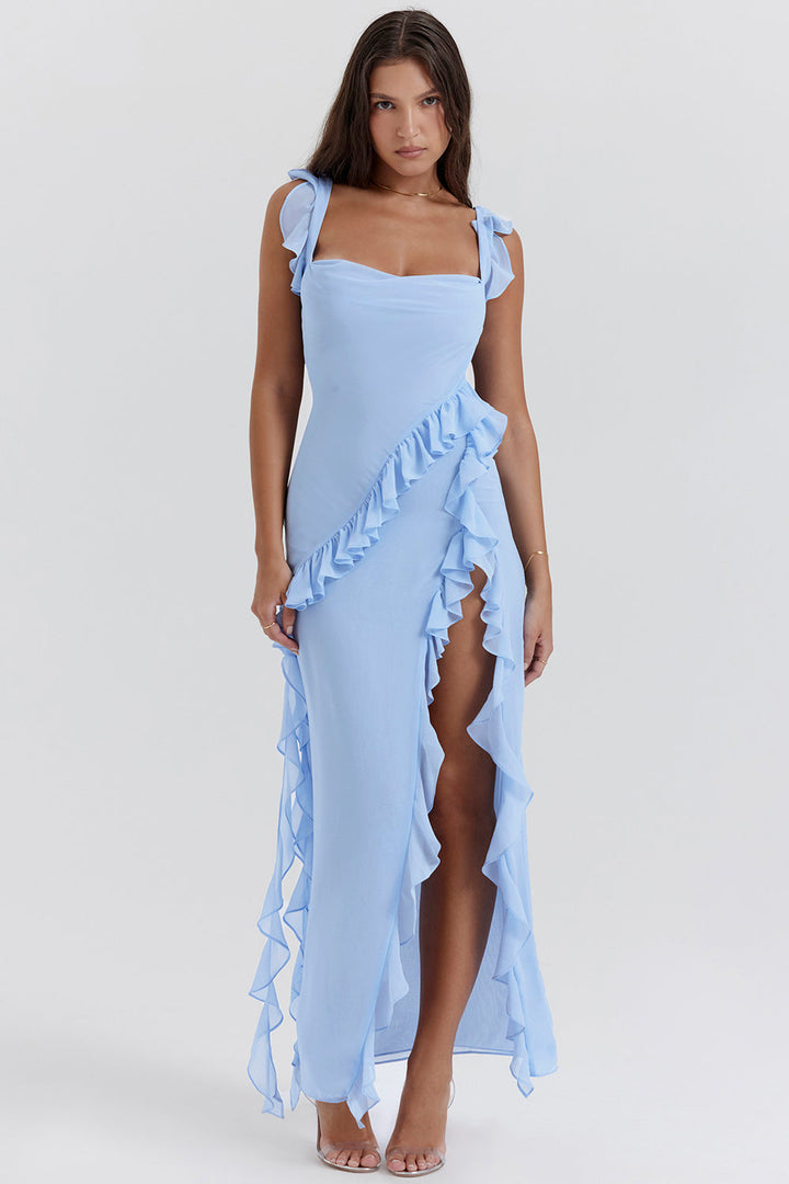 Front view of a model in a light blue georgette wedding guest dress with ruffled straps and a high side split