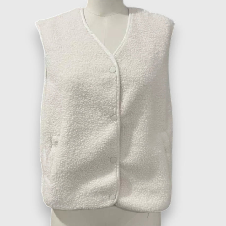 Front view, cream cosy fleece vest on a mannequin, showing the soft sherpa texture and button details