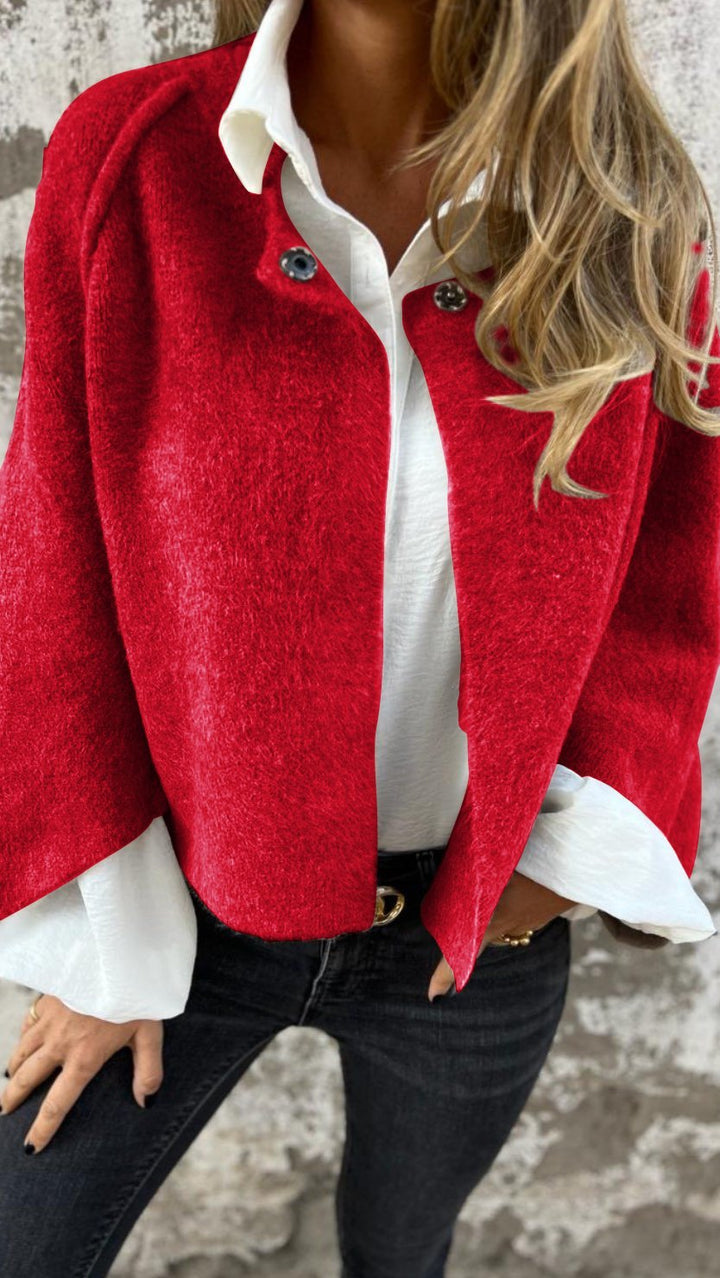 Bright red wool coat open over a white shirt and black jeans