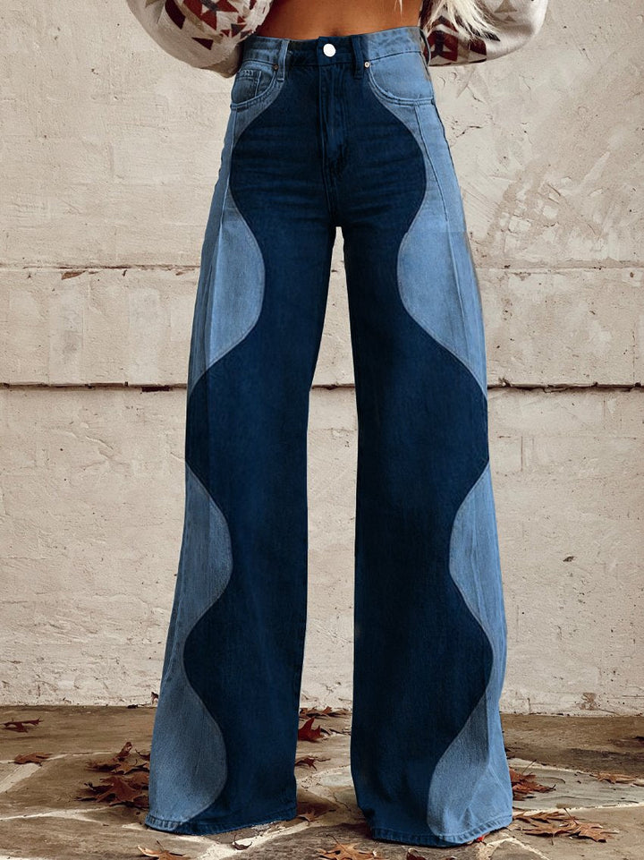 Detail of high-waisted wide leg boho vintage pants with wavy light and dark denim panels worn by model