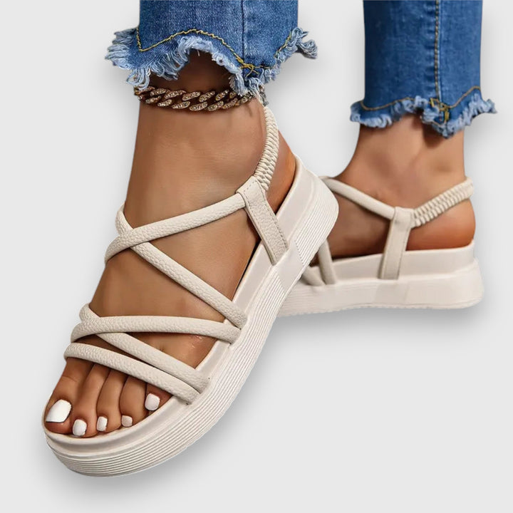 Front view worn by model, cream comfort platform sandals with elastic strap and criss-cross front straps