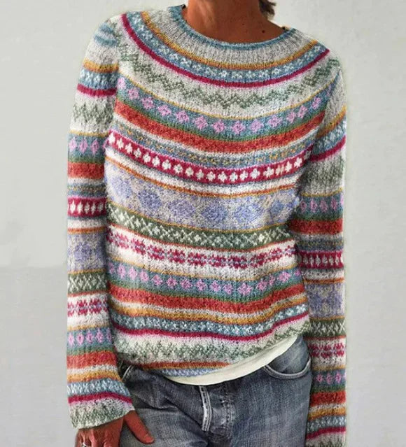 Close up front view of a woman wearing a retro Nordic knit jumper with colourful patterns