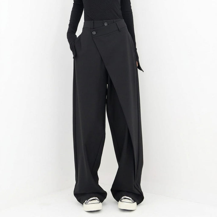 Front view, model wearing black avant-garde tailored pants with a unique wrap waist and baggy fit