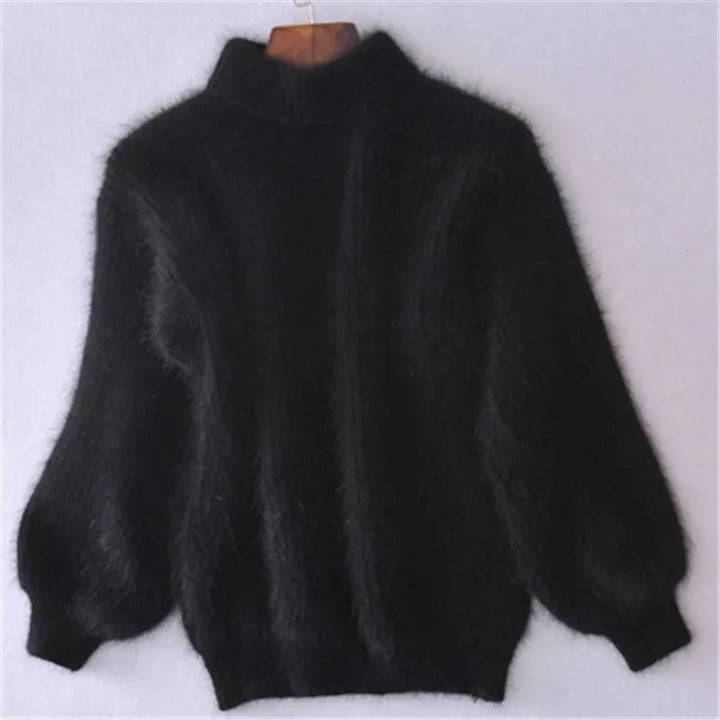 Front view of a black angora wool jumper with a high neck and voluminous sleeves on a hanger