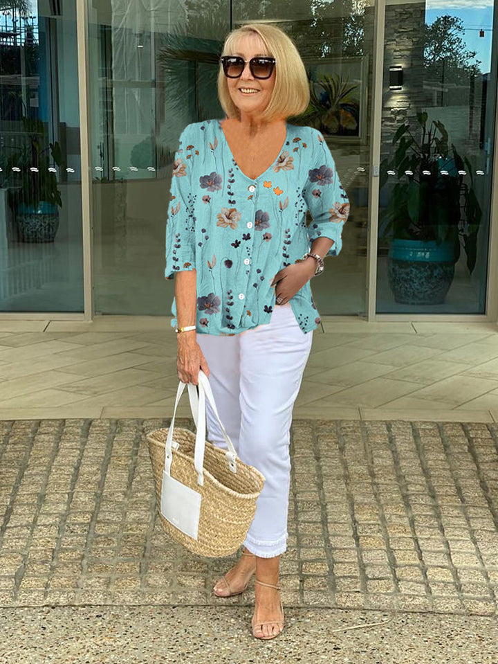 Light blue floral chiffon button up blouse with white capri trousers