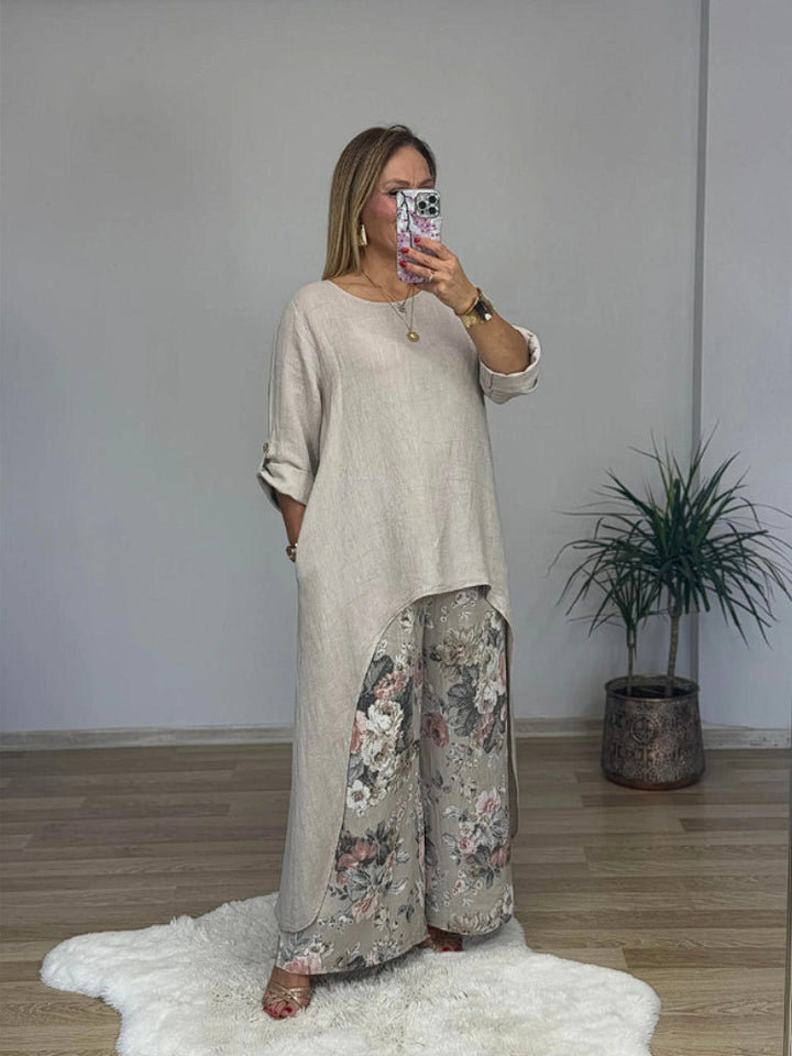 Front view of a model in a long-sleeve top and floral printed pants set, taking a mirror selfie