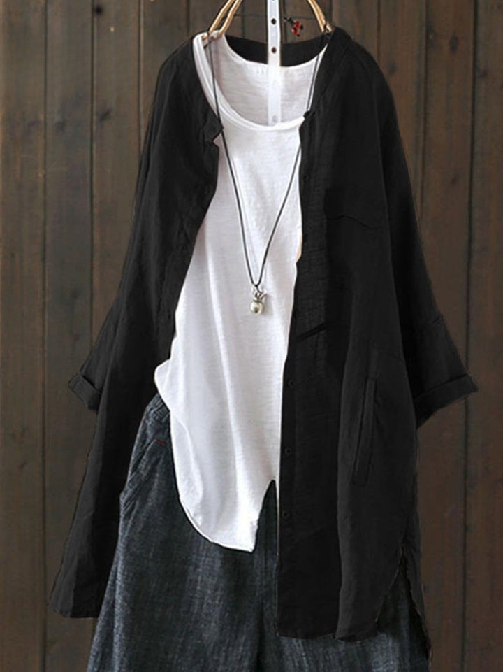 Black loose casual top jacket over a white top and dark trousers