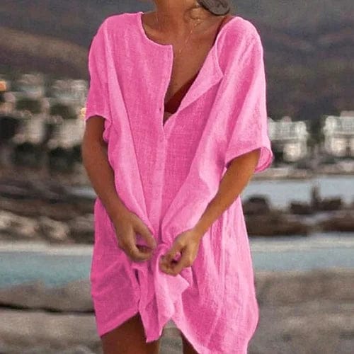 Front view, model wearing a pink Ingrid short sleeve linen blouse over a dark top, tied at the front