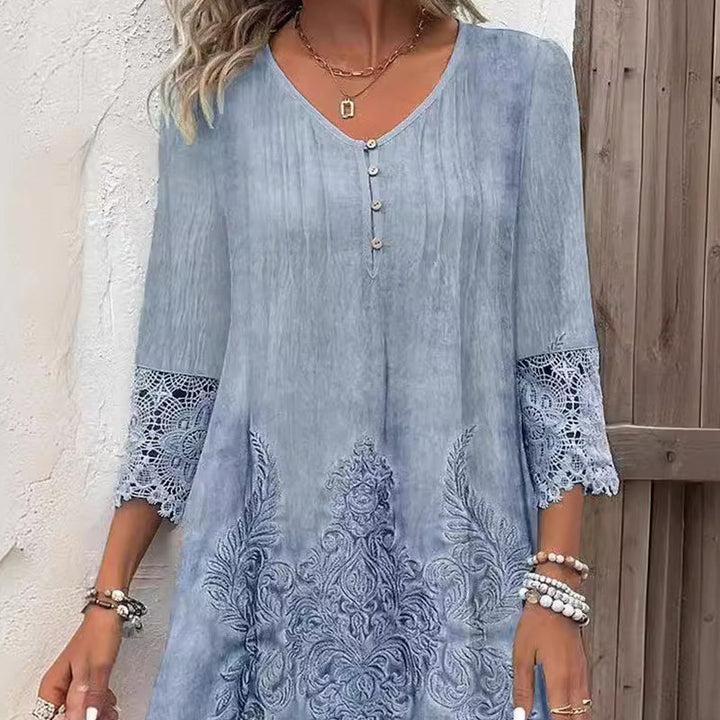 Close up of an elegant lace dress with ornamental details on the hem and sleeves worn by a model