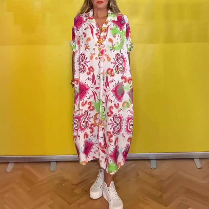 Front view of a model wearing a loose elegant floral dress with a collared neckline, short sleeves and white platform shoes