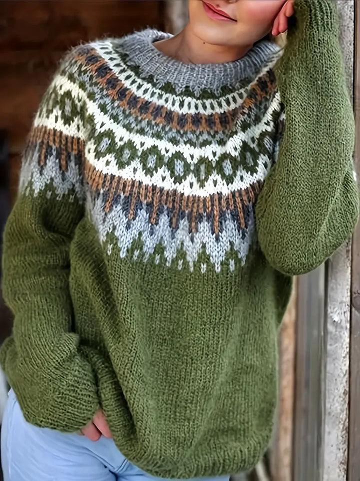 Front view of a model wearing a green Icelandic winter sweater with a patterned yoke in grey, white, and brown
