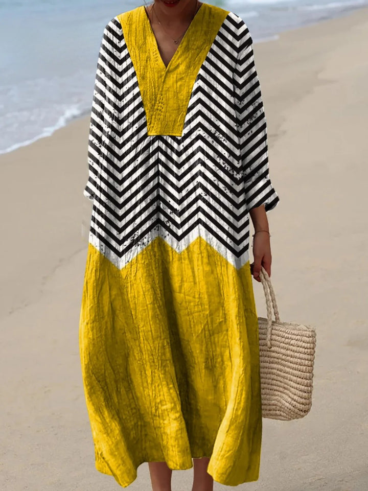 Front view of a model wearing the cotton irregular geometric art print dress on a beach