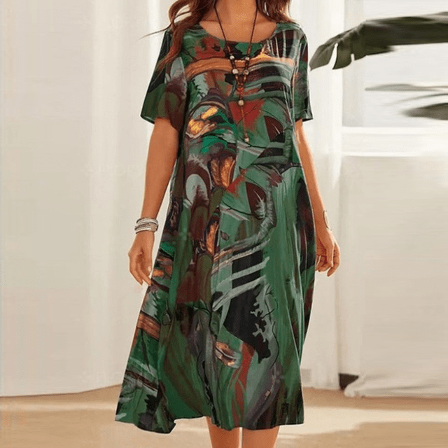 Front view of the floral midi dress with a green, brown and black abstract print worn by a model