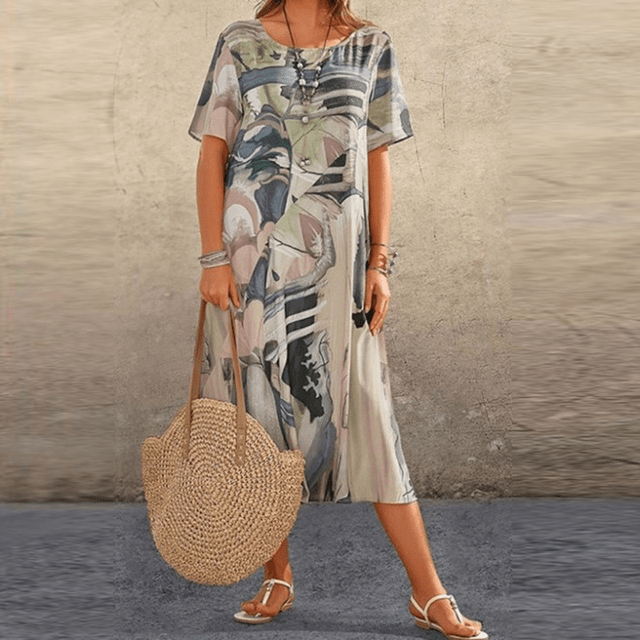 Front view of the floral midi dress with a beige, black and grey abstract print worn by a model