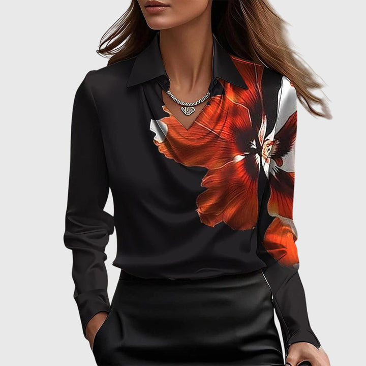 Front view of a model wearing the Autumn Satin Vintage Long Sleeve Blouse in black with a large red floral print
