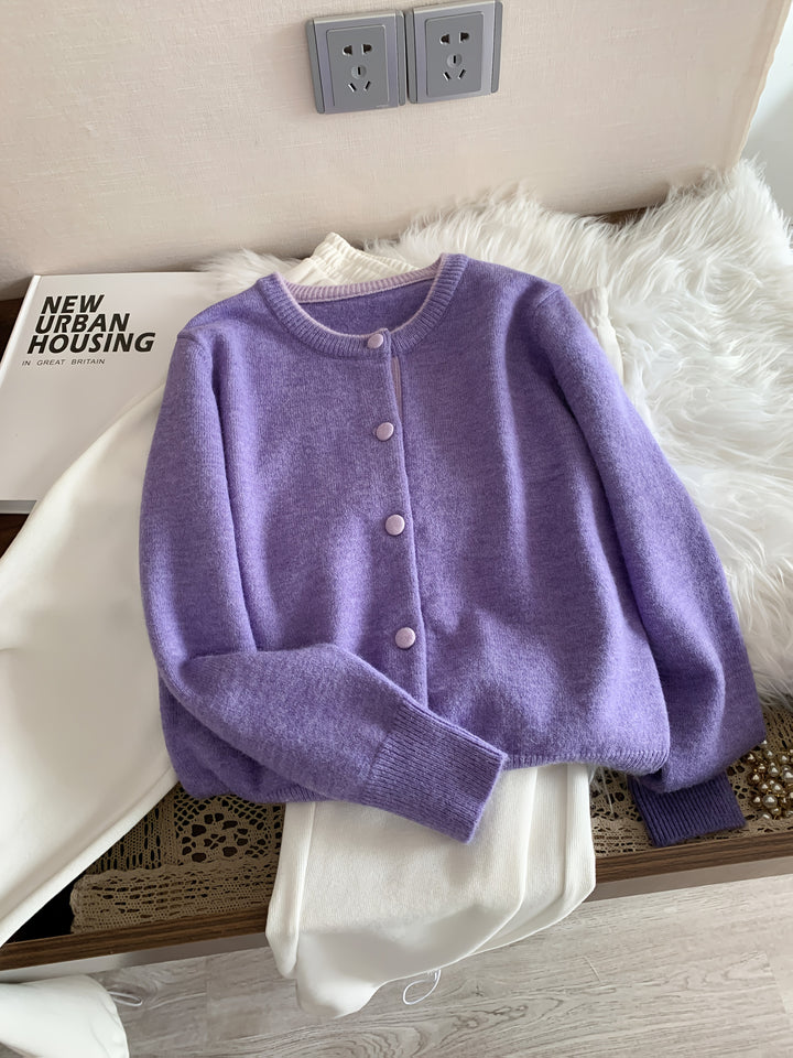 Front view of a purple knitted buttoned cardigan with light purple buttons and trim
