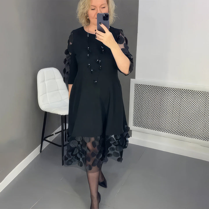 Oversized maxi dress worn by model, front view, featuring A-line silhouette with sheer polka dot hem and sleeves