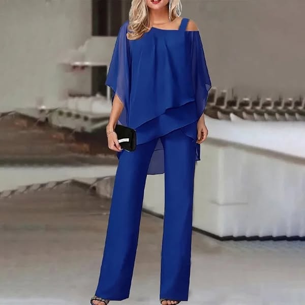 Front view, model wearing elegant straight-leg trousers and flowing top set in royal blue with black clutch and heels